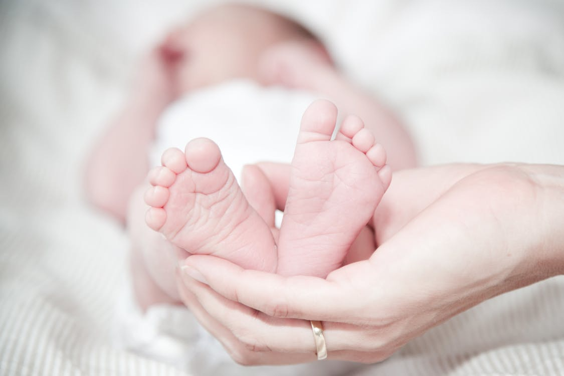 Doctor examining a child’s foot during clubfoot treatment consultation